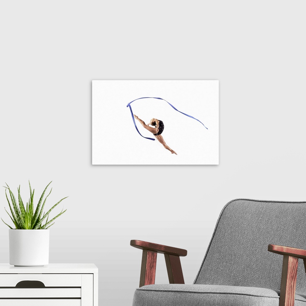 A modern room featuring Female Athlete Jumping Gracefully Mid Air With a Ribbon
