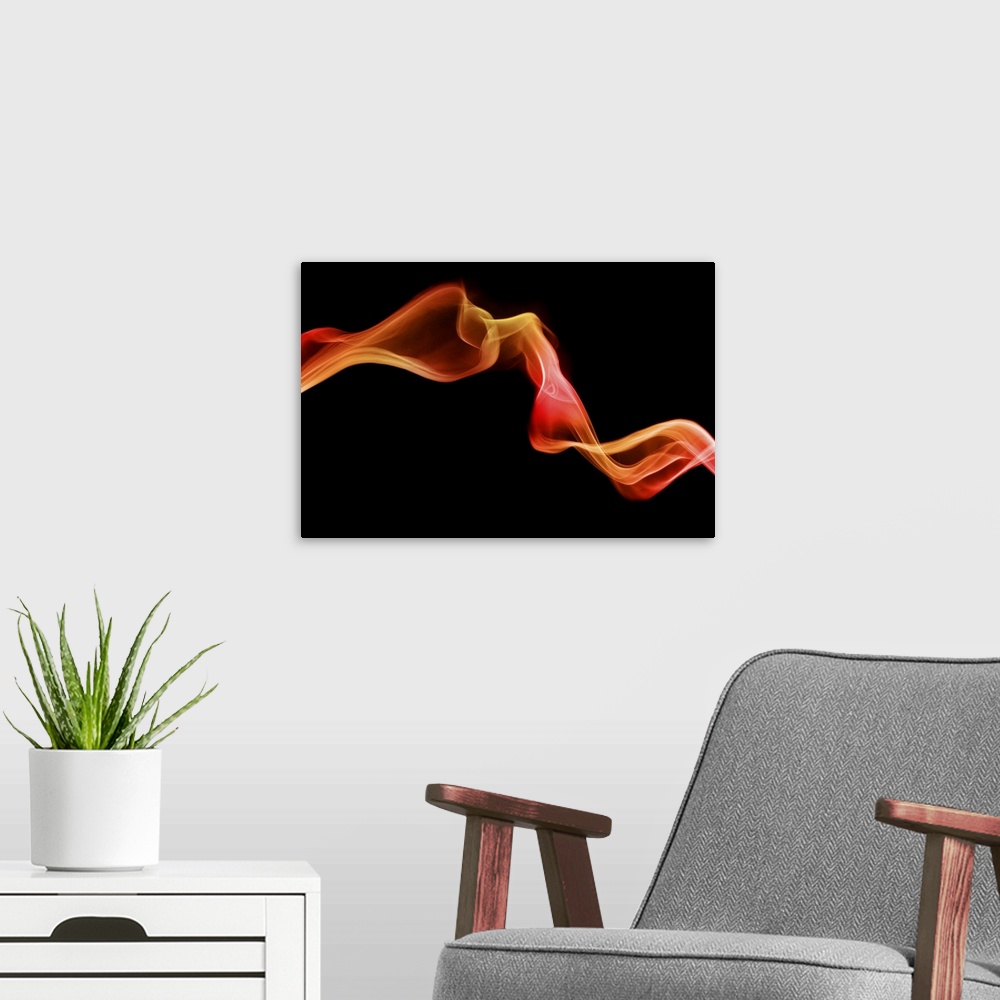 A modern room featuring Fiery coloured smoke in shades of red and orange twists across a black background.