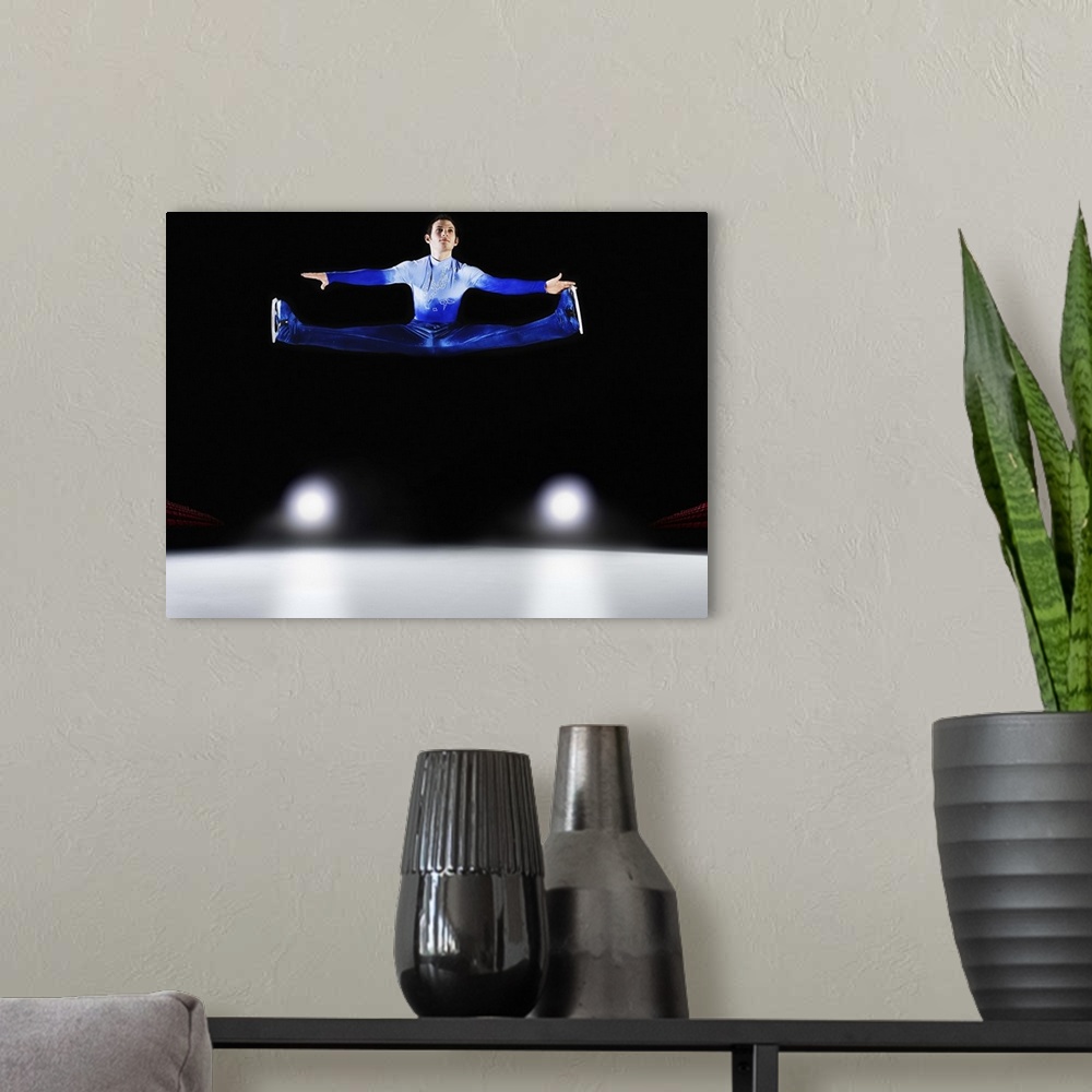 A modern room featuring Male figure skater performing Russian Split.
