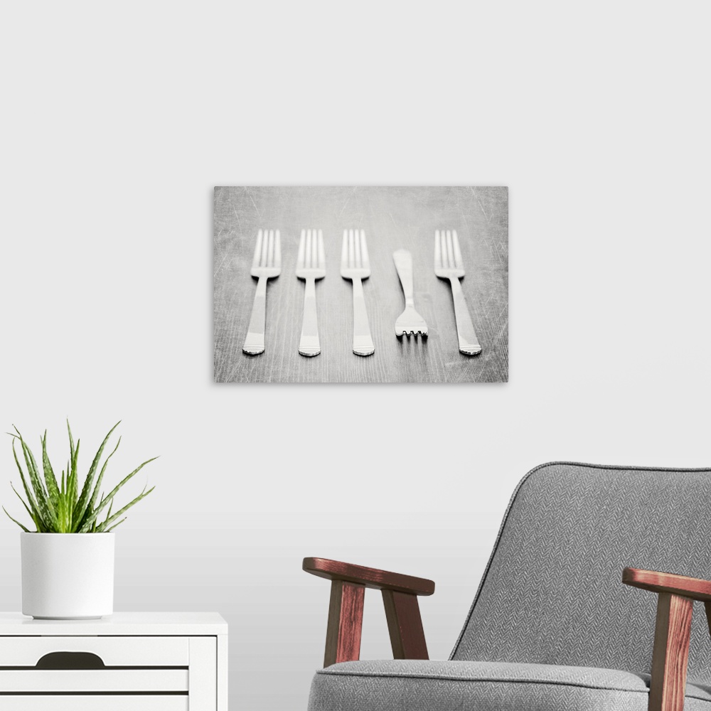 A modern room featuring Forks on tabletop, black and white textured image.