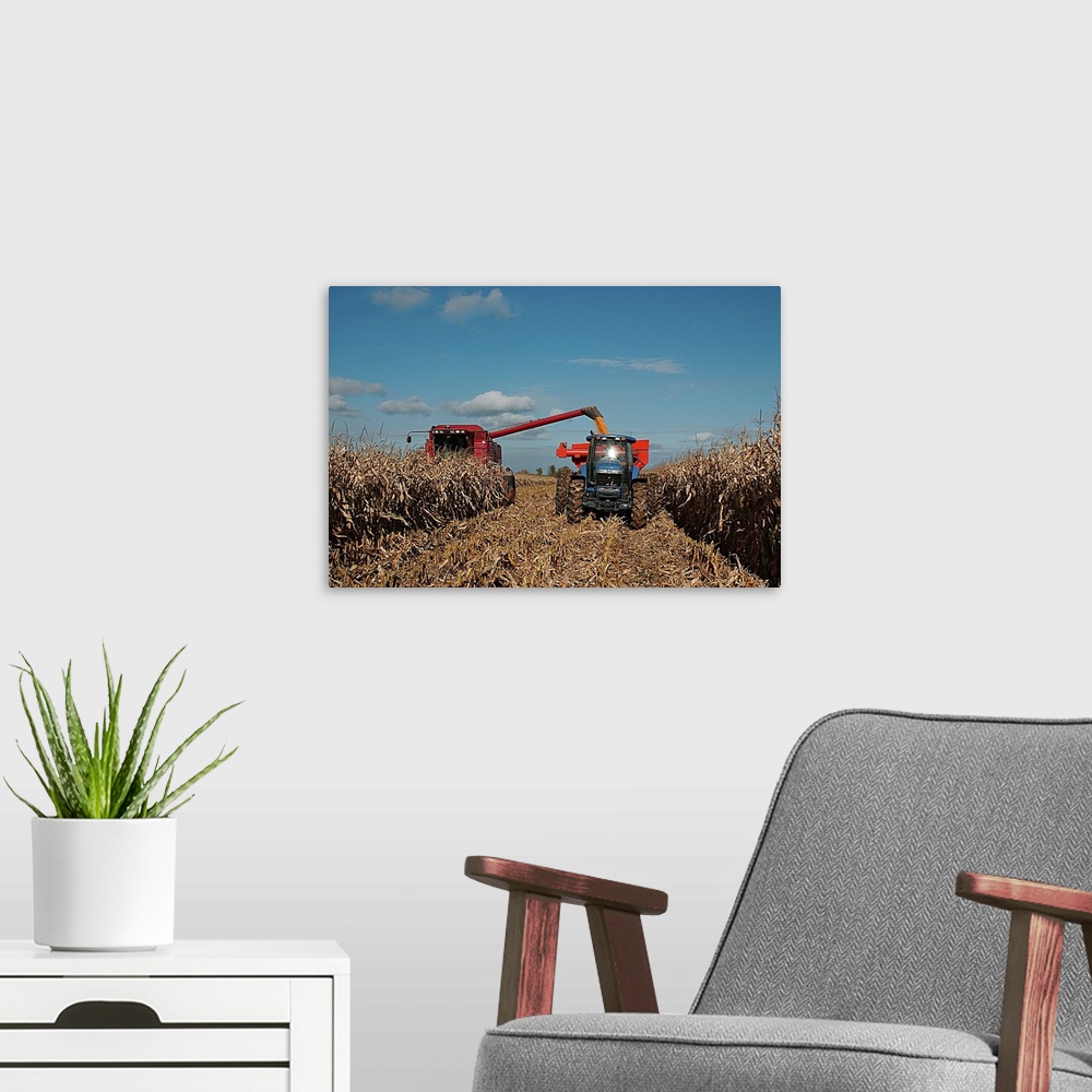 A modern room featuring Harvest of crop with combine and tractor