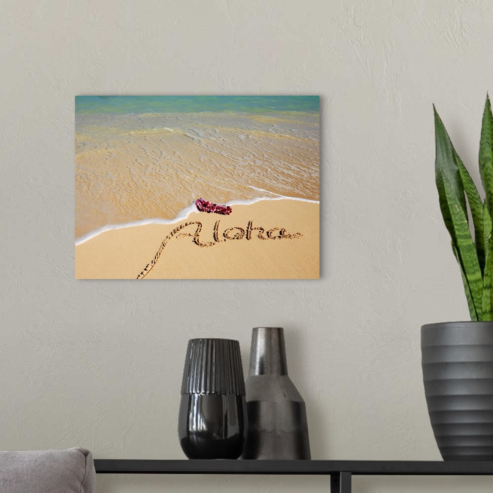 A modern room featuring Hawaii, Turquoise ocean waters, foaming shore water, orchid lei, Aloha written in sand