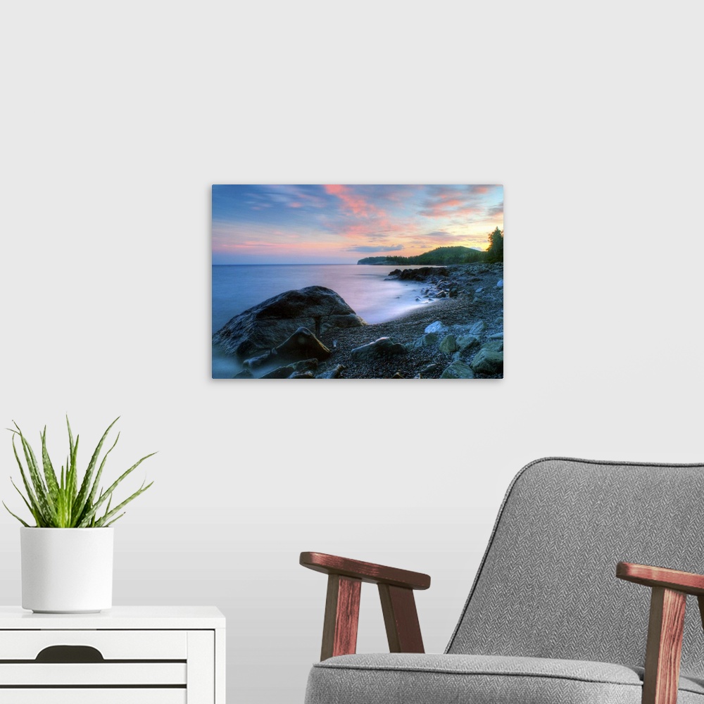 A modern room featuring Beautiful summer sunset along rocky shore of Lake Superior.