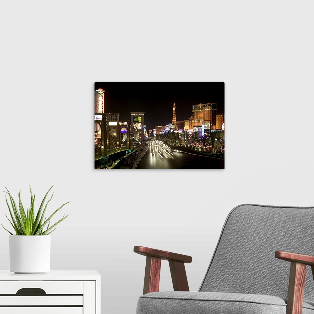 A modern room featuring Photograph of "Sin City" after sunset with buildings lit up in the dark sky.  A highway lined wit...