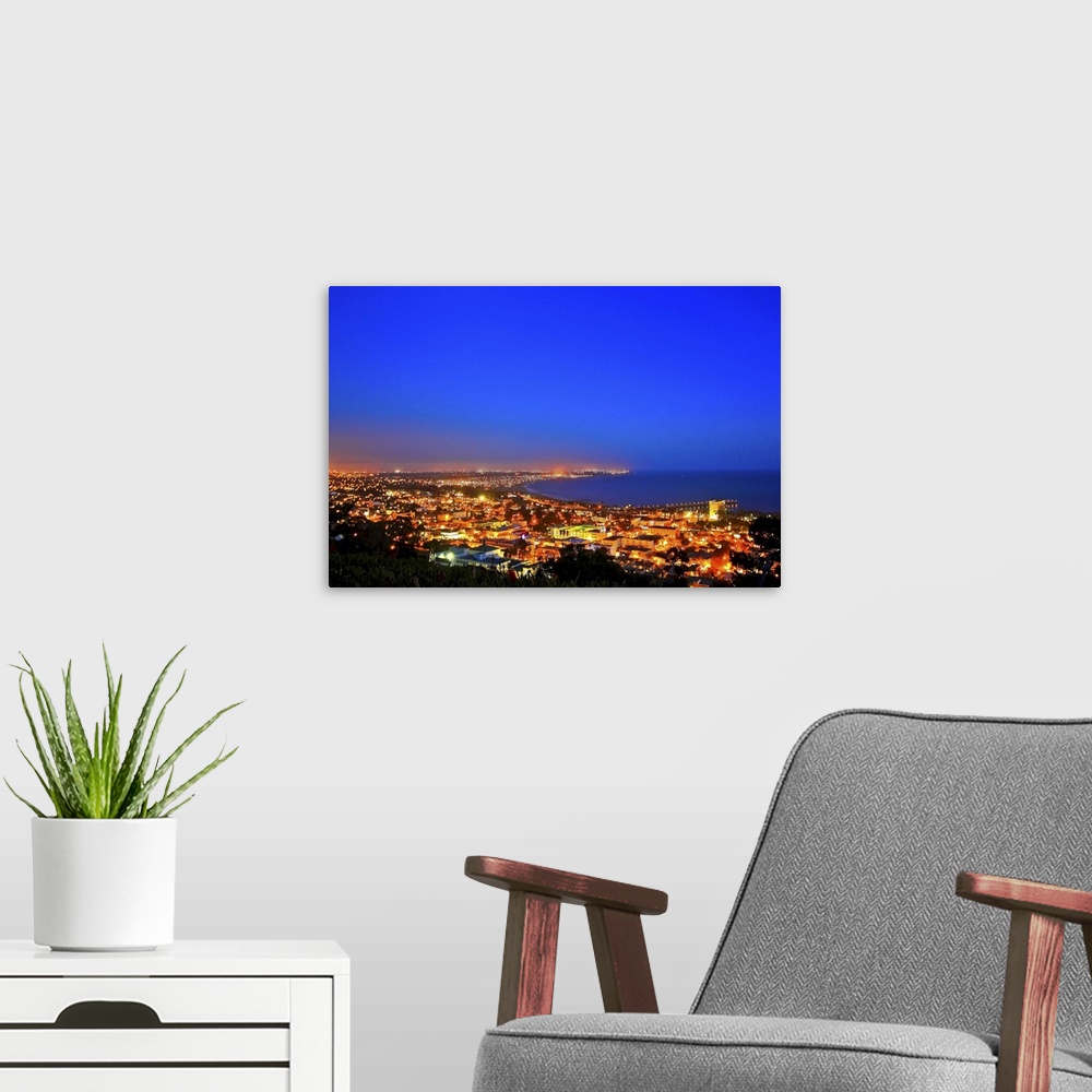 A modern room featuring Ventura County coast line after sunset.