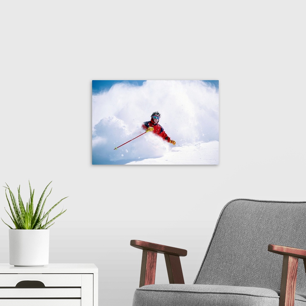 A modern room featuring Man downhill skiing in cloud of powdery snow