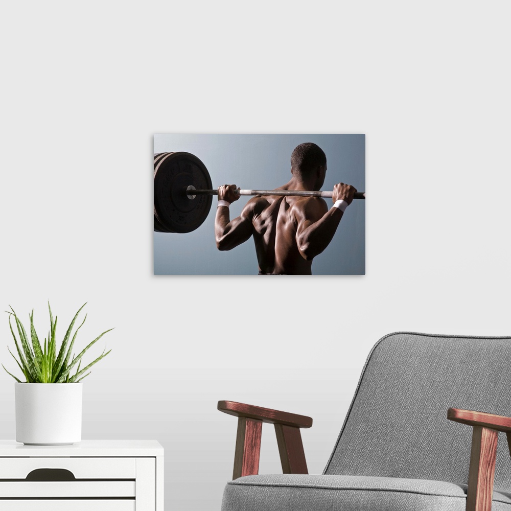A modern room featuring African American man working out the gym