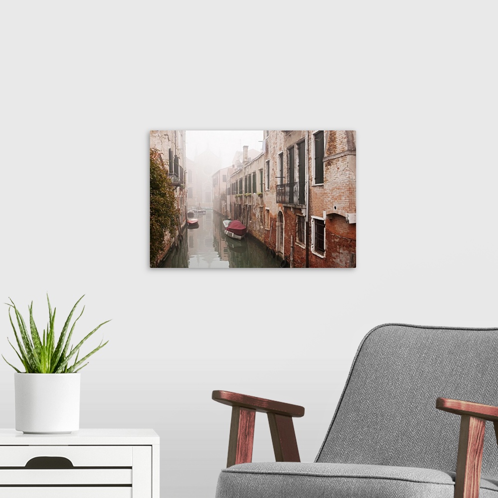 A modern room featuring Autumnal mists lie over the water of a small backwater canal on a quiet November morning in Venice.