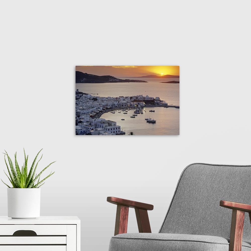 A modern room featuring Port of the island of Mykonos, one of the Cyclades islands in the Aegean sea at sunset.