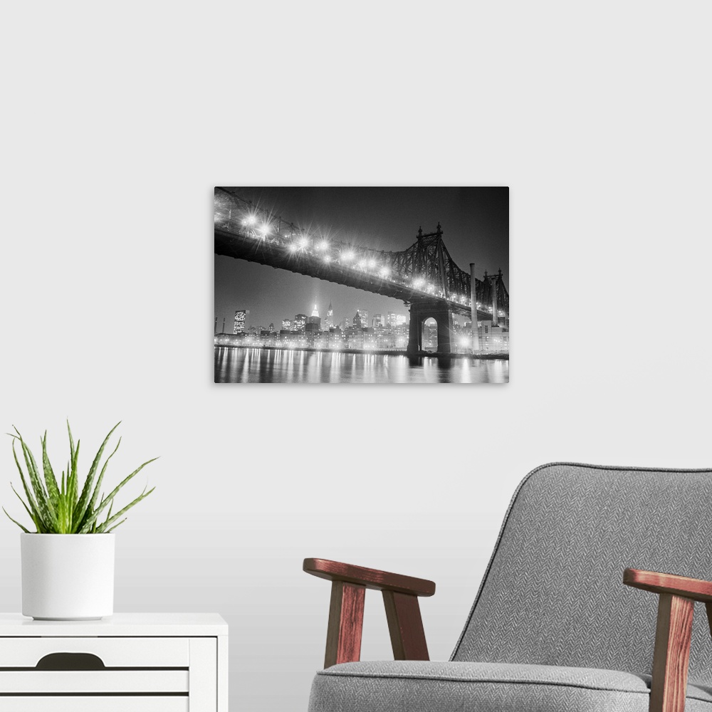 A modern room featuring New York:Manhattan's bright lights reflect on the East River below the Queensboro Bridge. It was ...