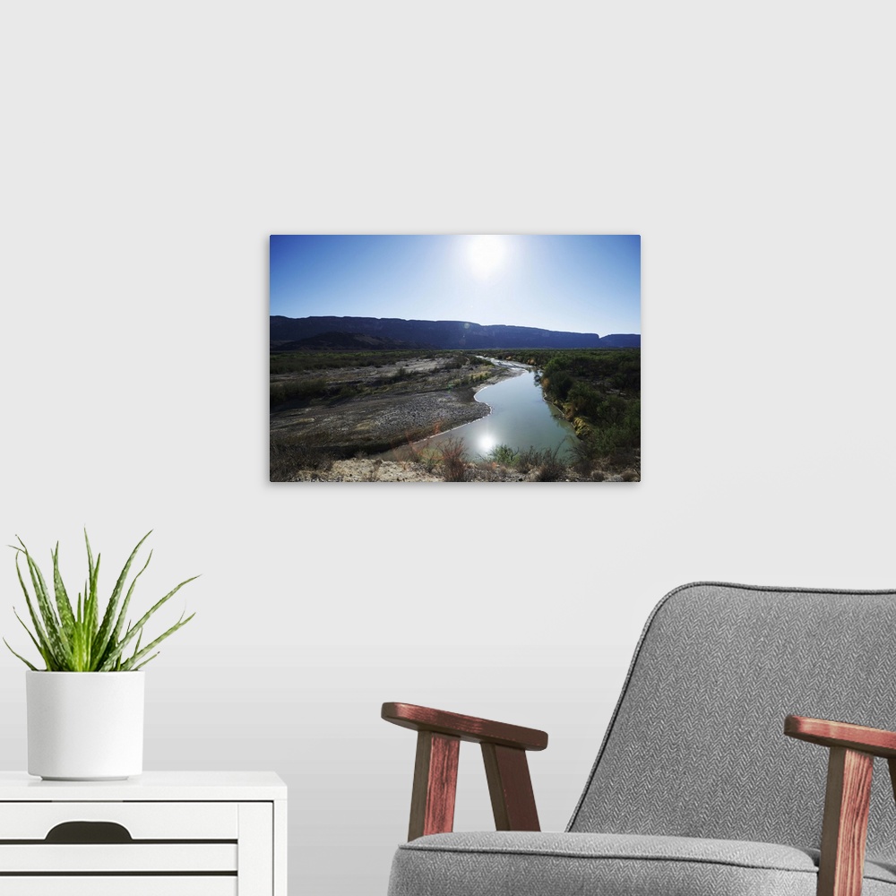 A modern room featuring The Rio Grande river at Big Bend Park in West Texas. Mexico is on the left of the frame and the U...