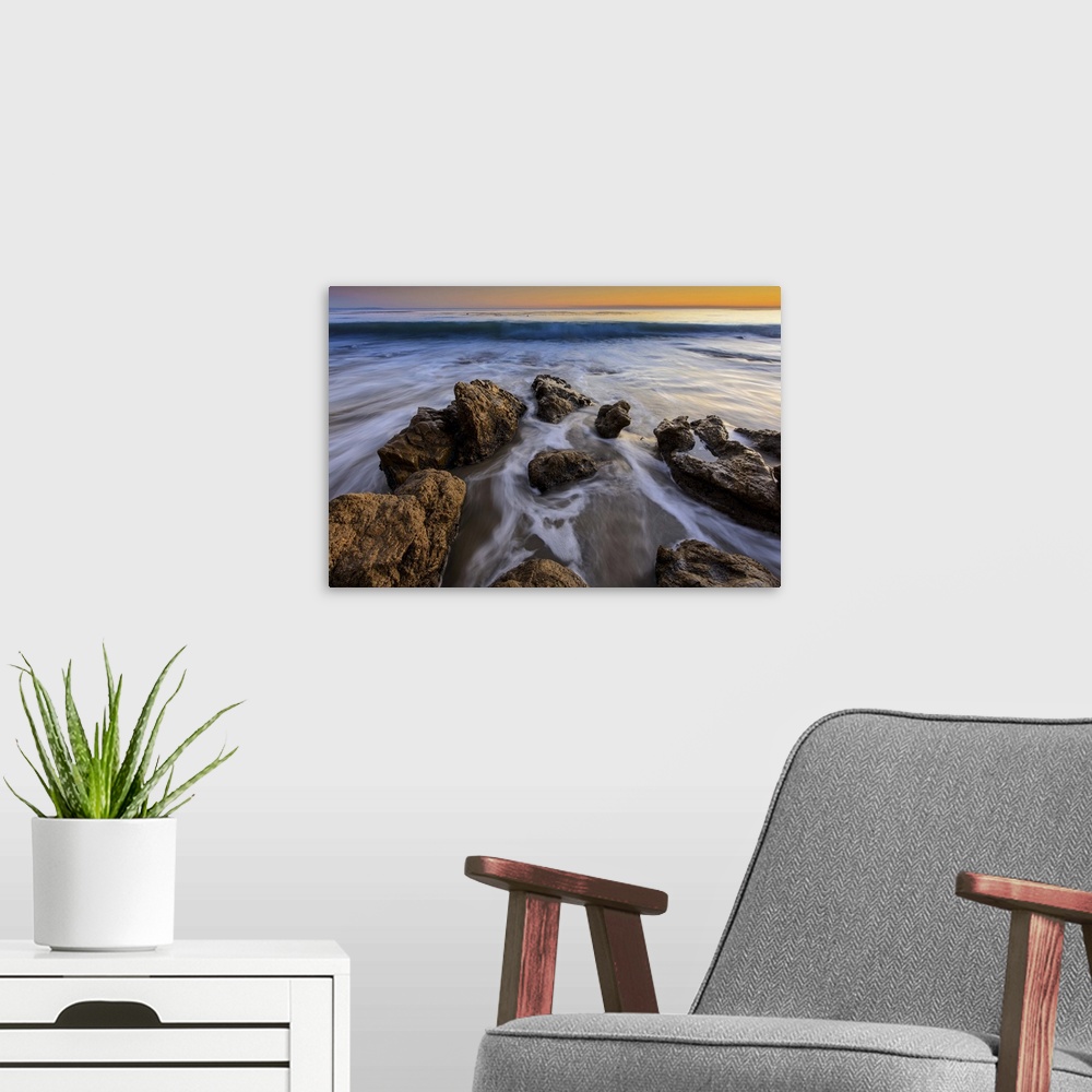 A modern room featuring Wave approaching on a rock beach in Malibu, CA