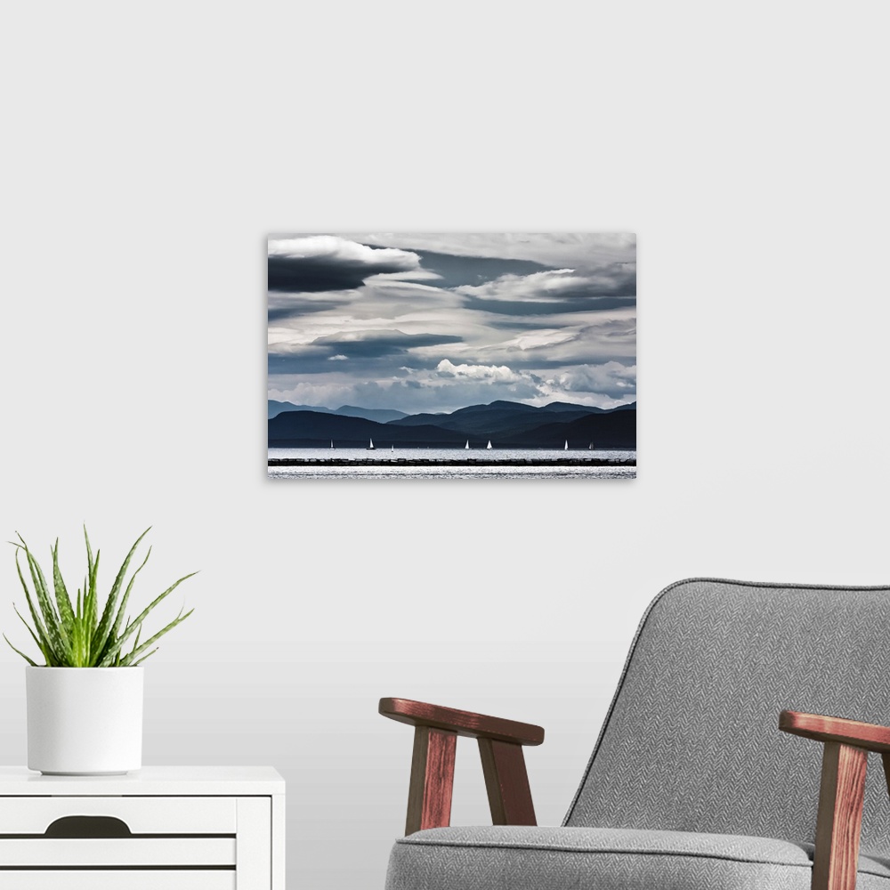 A modern room featuring Sail boats sailing on Lake Champlain against beautiful white sky.