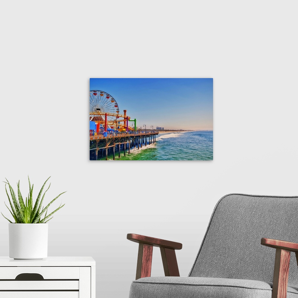 A modern room featuring View over to Pacific Park, family amusement park with large Ferris wheel at Santa Monica Pier in ...