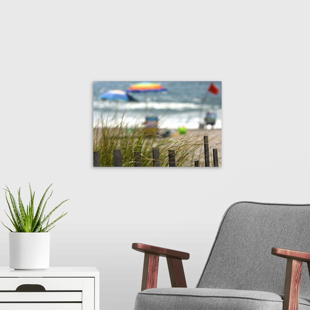 A modern room featuring Selective focus of tourists enjoying the beach