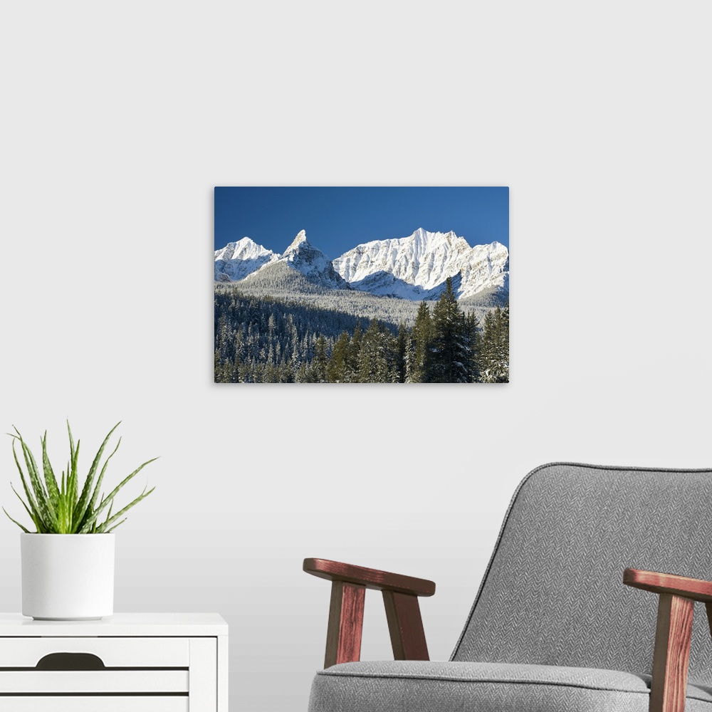 A modern room featuring Snow covered mountain range against a deep blue sky, Canada