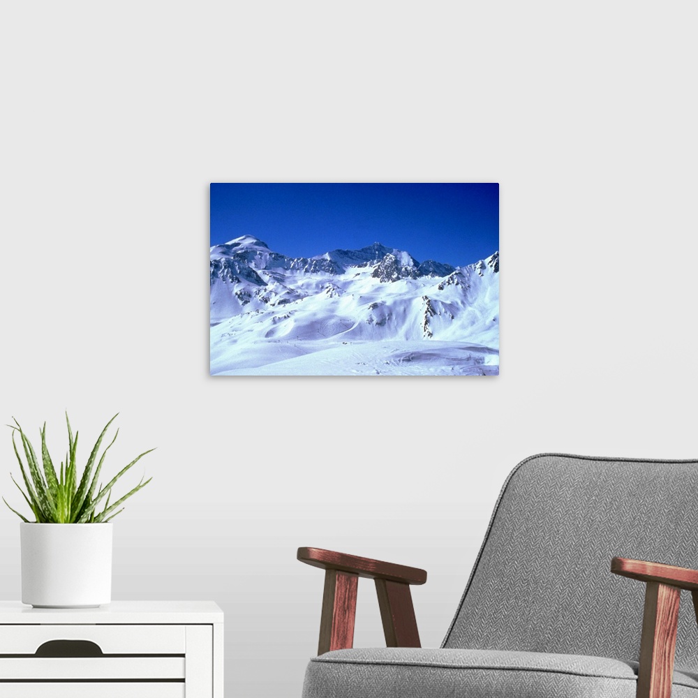 A modern room featuring snowy mountains