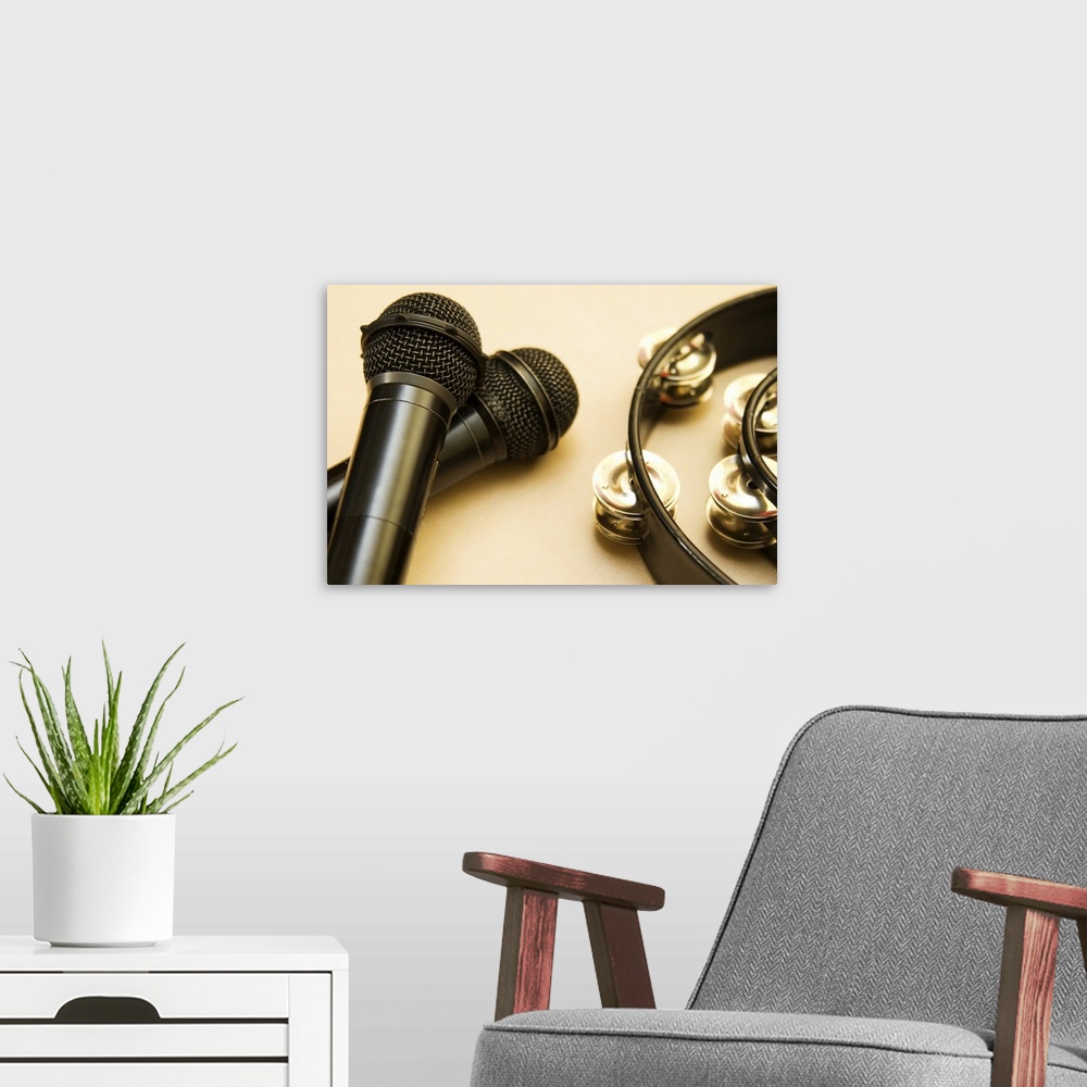A modern room featuring Still Life image of tambourine and microphone