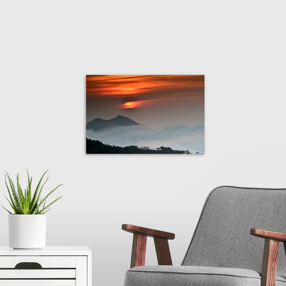 A modern room featuring Sunrise against beautiful landscape and fog.
