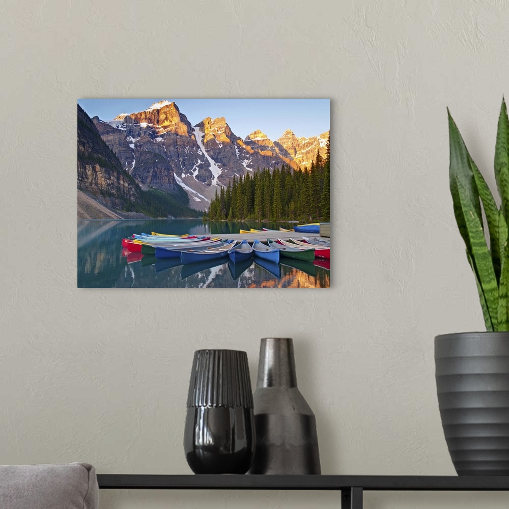 A modern room featuring Sunrise on Moraine Lake and colorful canoes in Banff National Park, Alberta, Canada.