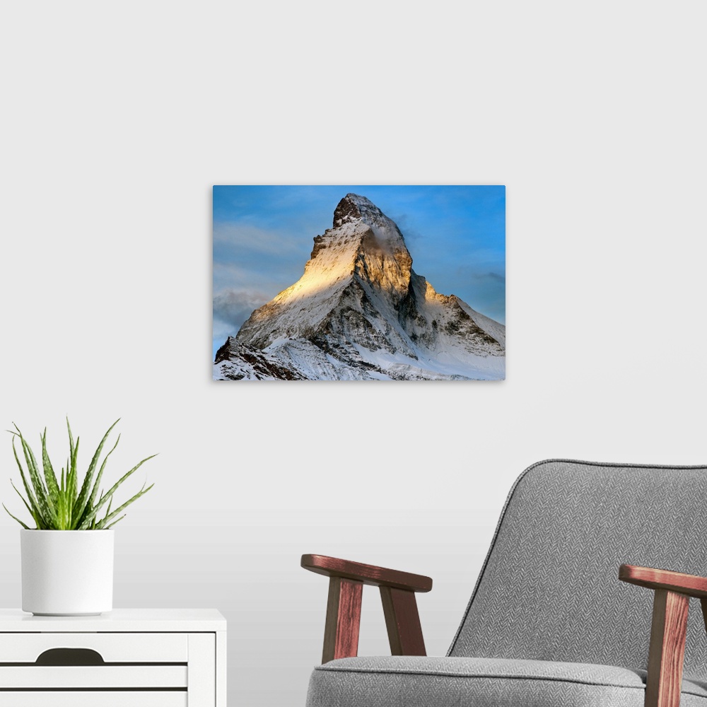 A modern room featuring The peak of the Matterhorn at sunrise.