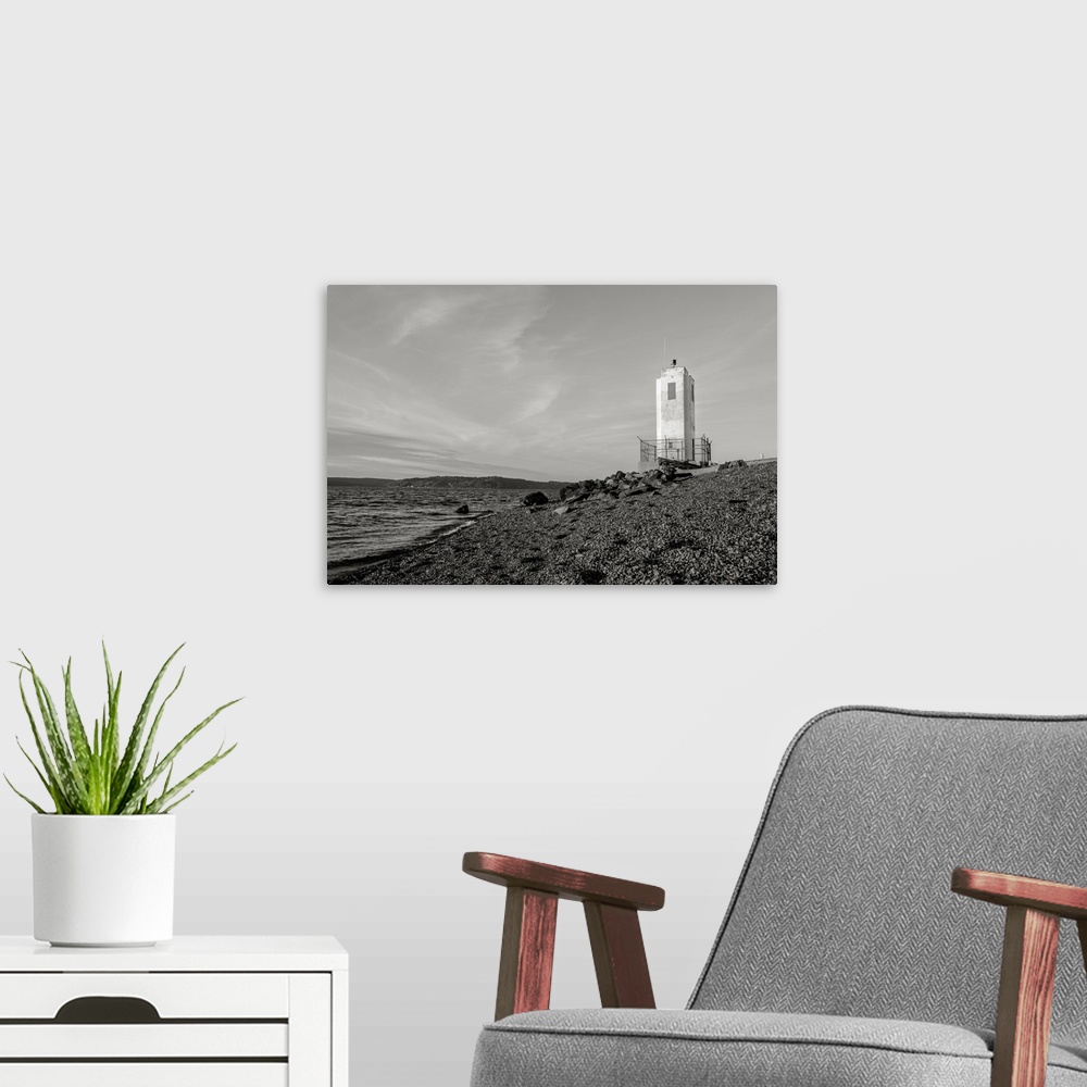 A modern room featuring A black and white photograph of the Puget Sound and lighthouse at Browns Point, Washington.