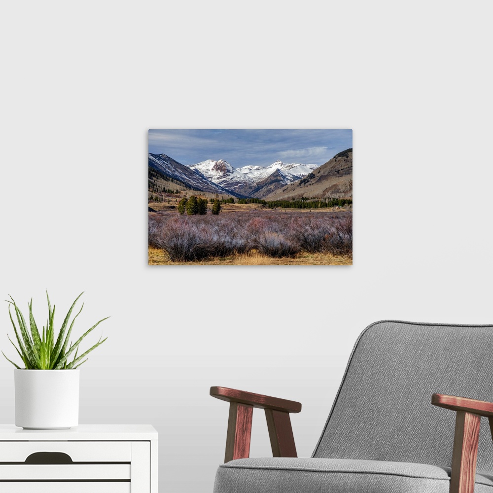 A modern room featuring The north view from Crested Butte, Colorado, features panoramic views of snow-capped mountains.