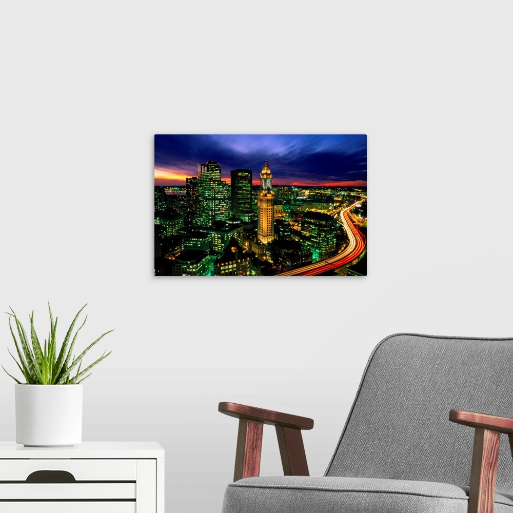 A modern room featuring Time lapsed evening photograph of the Custom House Tower and the highway that passes in front of it.