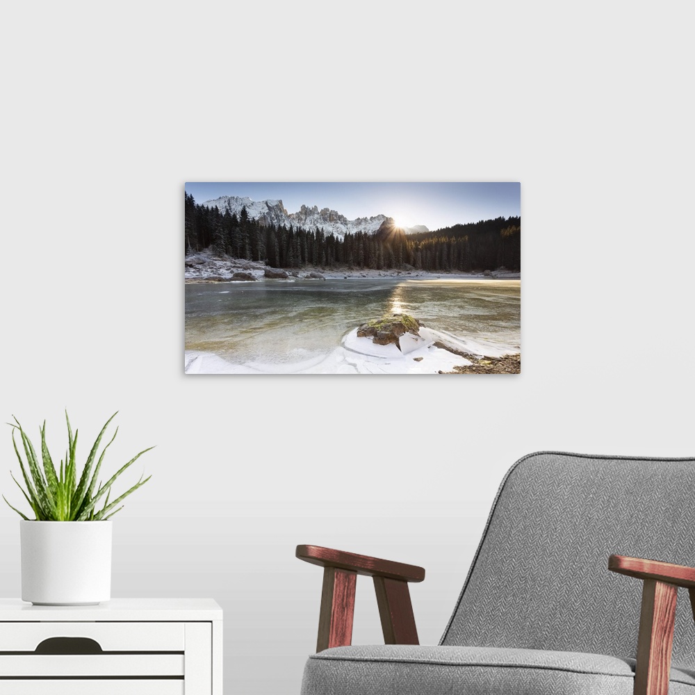 A modern room featuring A suggestive sunset at Karersee where the last sun reflected on the iced lake, Bolzano province, ...