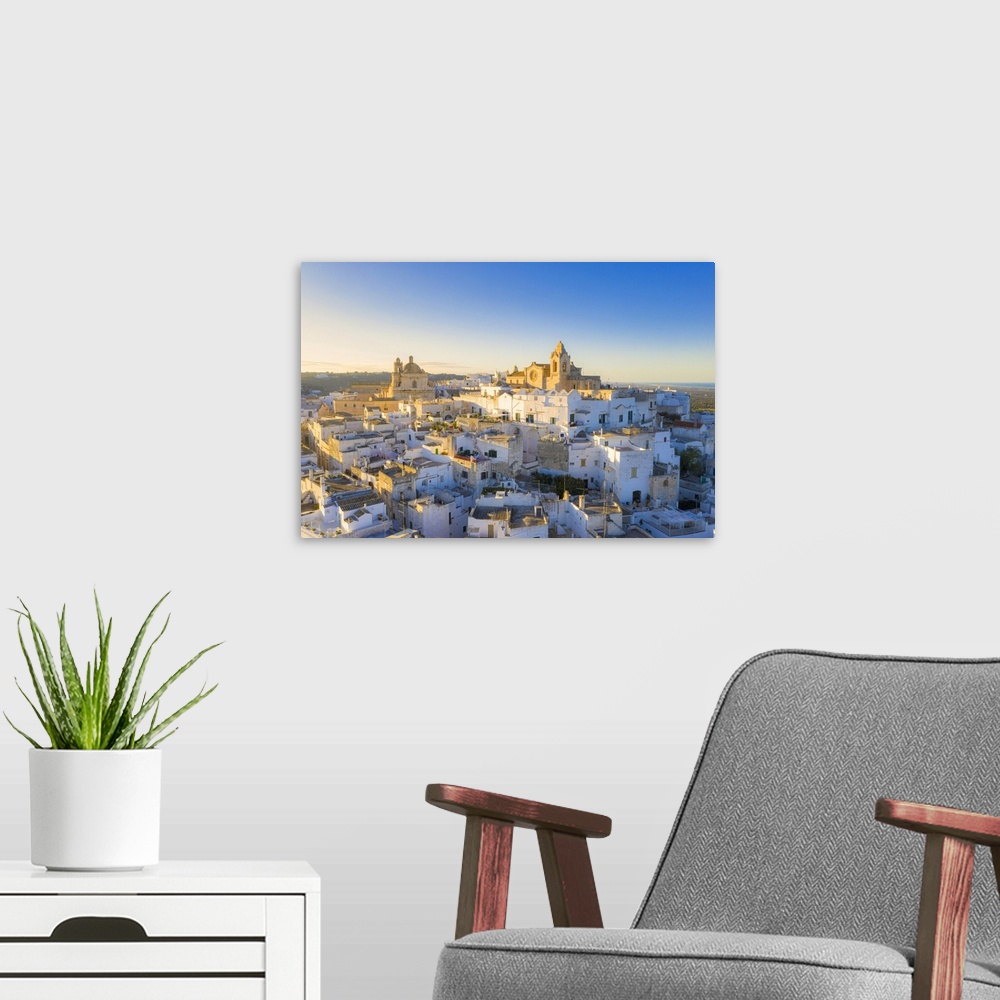 A modern room featuring Aerial view of the old town of Ostuni at sunset, Apulia, Italy
