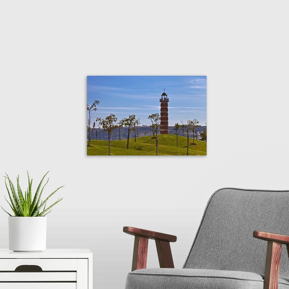 A modern room featuring Belem Lighthouse at the entrance to the River Tagus Estuary with landscaped mounds and trees in t...