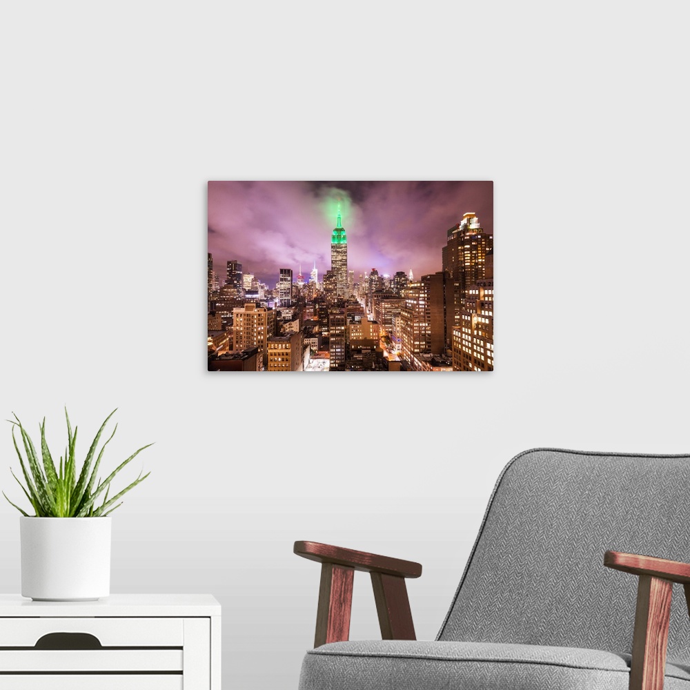 A modern room featuring Empire state building and view of the rooftops of Manhattan, New York, USA.