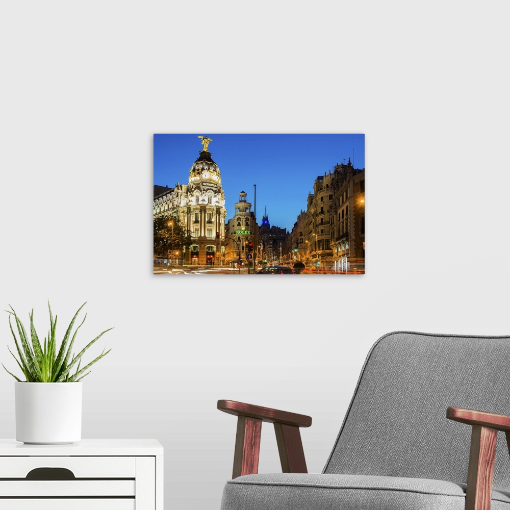 A modern room featuring Night view of Gran Via street and Metropolis Building with car light trails, Madrid, Comunidad de...