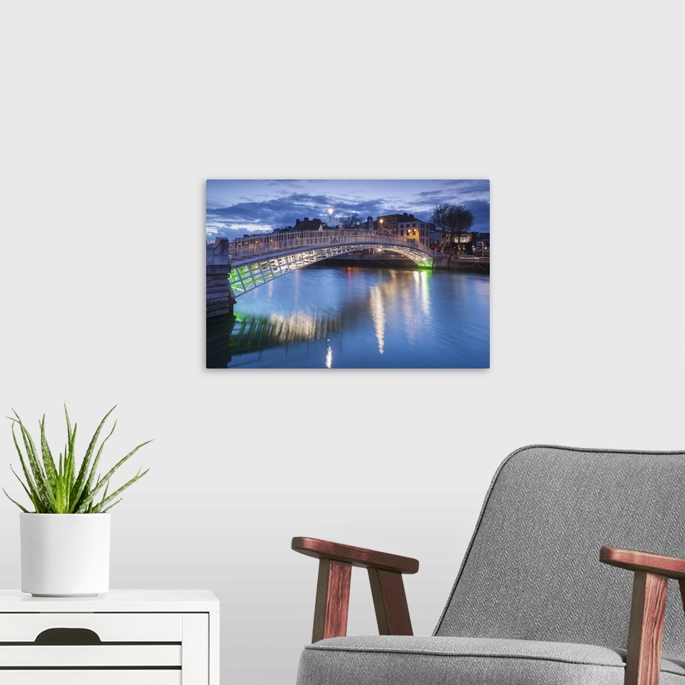 A modern room featuring Ireland, Dublin, Hapenny Bridge over the River Liffey, dusk.