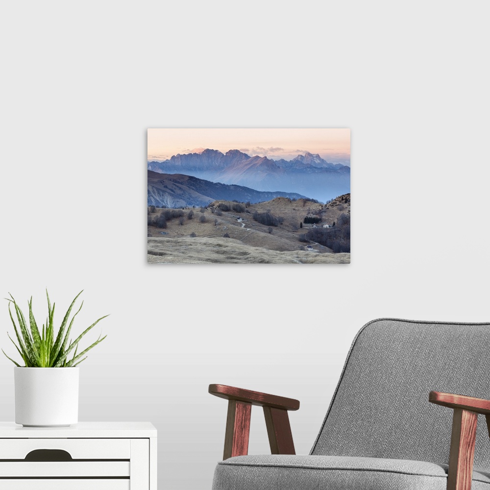 A modern room featuring Europe, Italy, Veneto, Treviso, Cansiglio. View towards the Dolomites from mount Pizzoc at sunset.