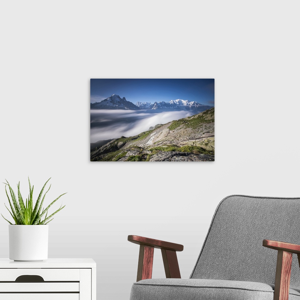 A modern room featuring Low clouds and mist frame the snowy peaks of Mont Blanc and Aiguille Verte, Chamonix, Haute Savoi...