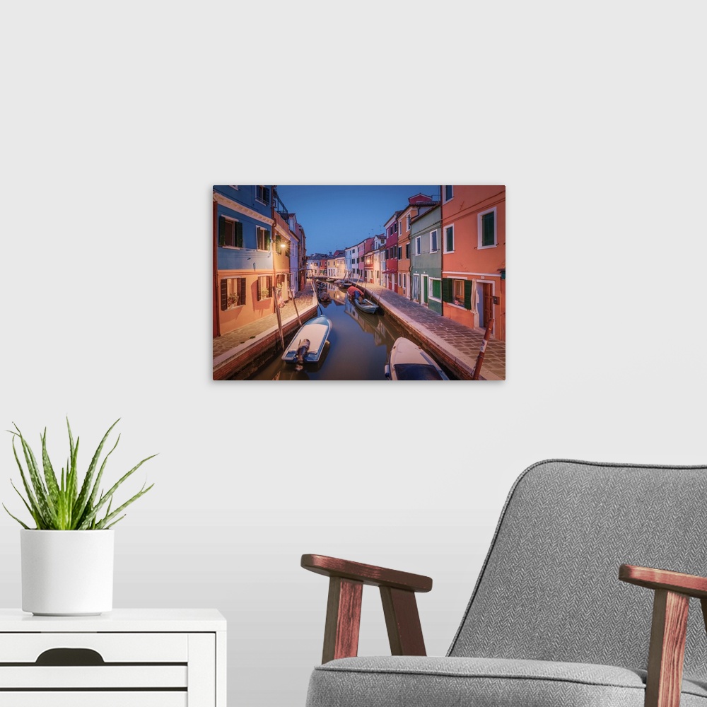 A modern room featuring One of the typical canals of the island of Burano at evening, Laguna di Venezia, Venice, Veneto, ...