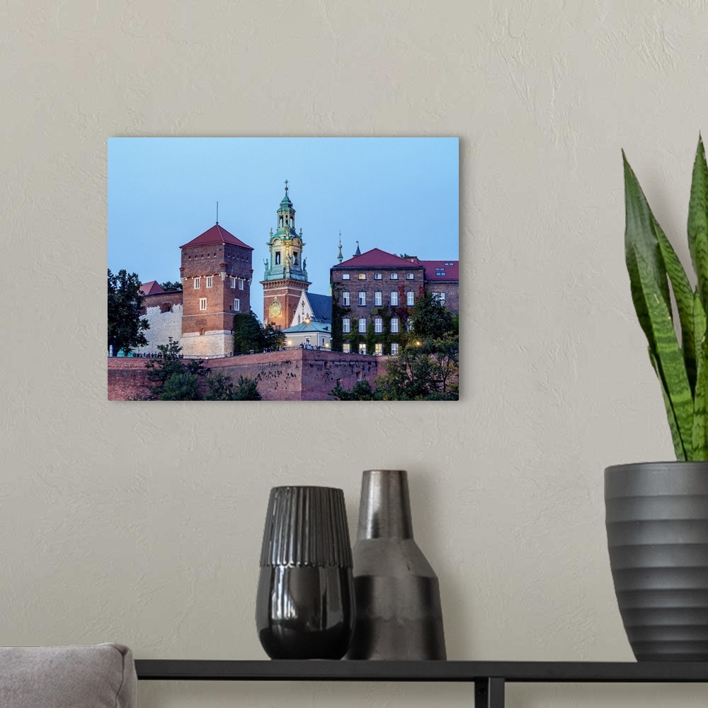 A modern room featuring Poland, Lesser Poland Voivodeship, Cracow, Wawel Royal Castle at twilight.