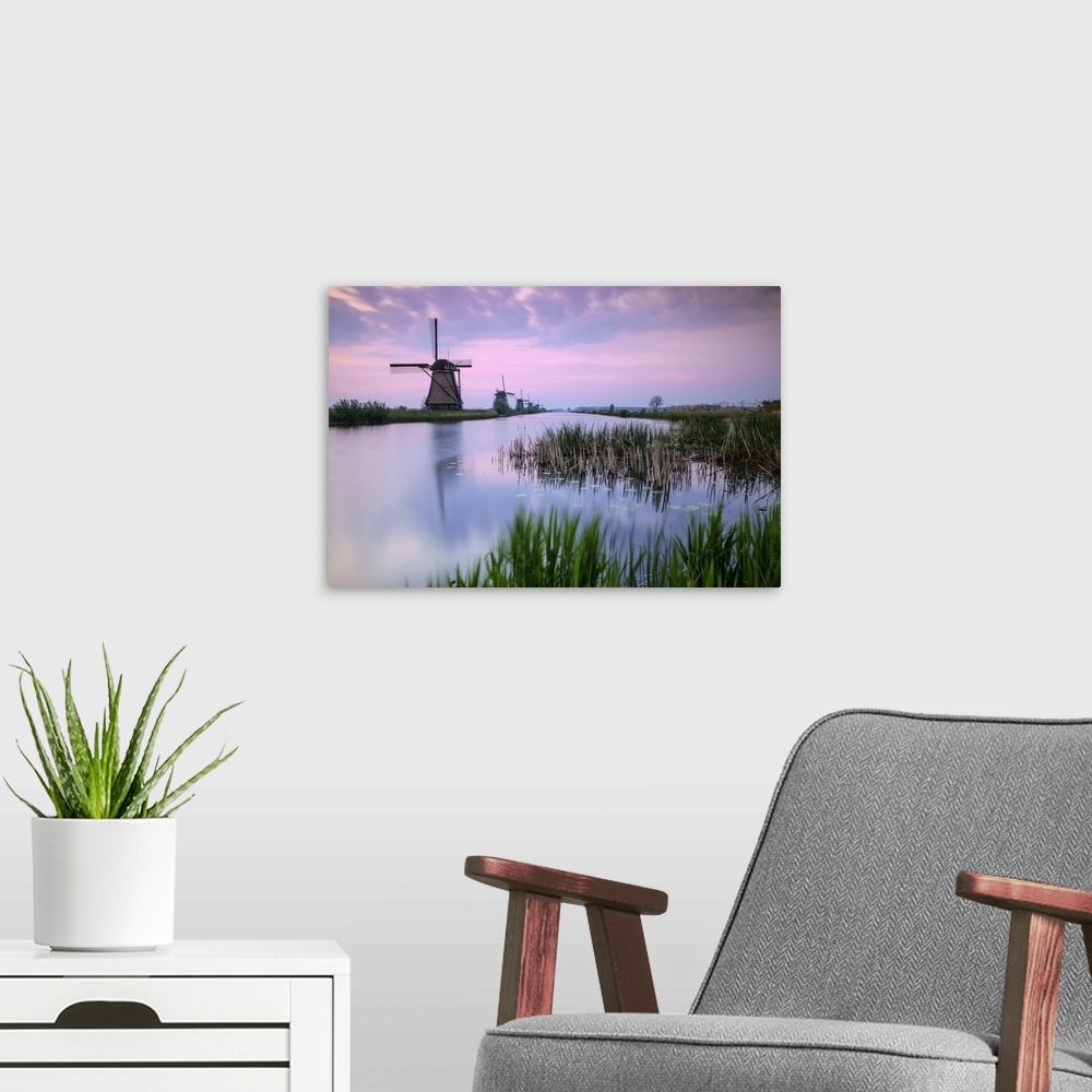 A modern room featuring Sky is tinged with purple at dawn on the windmills reflected in the canal Kinderdijk Rotterdam So...