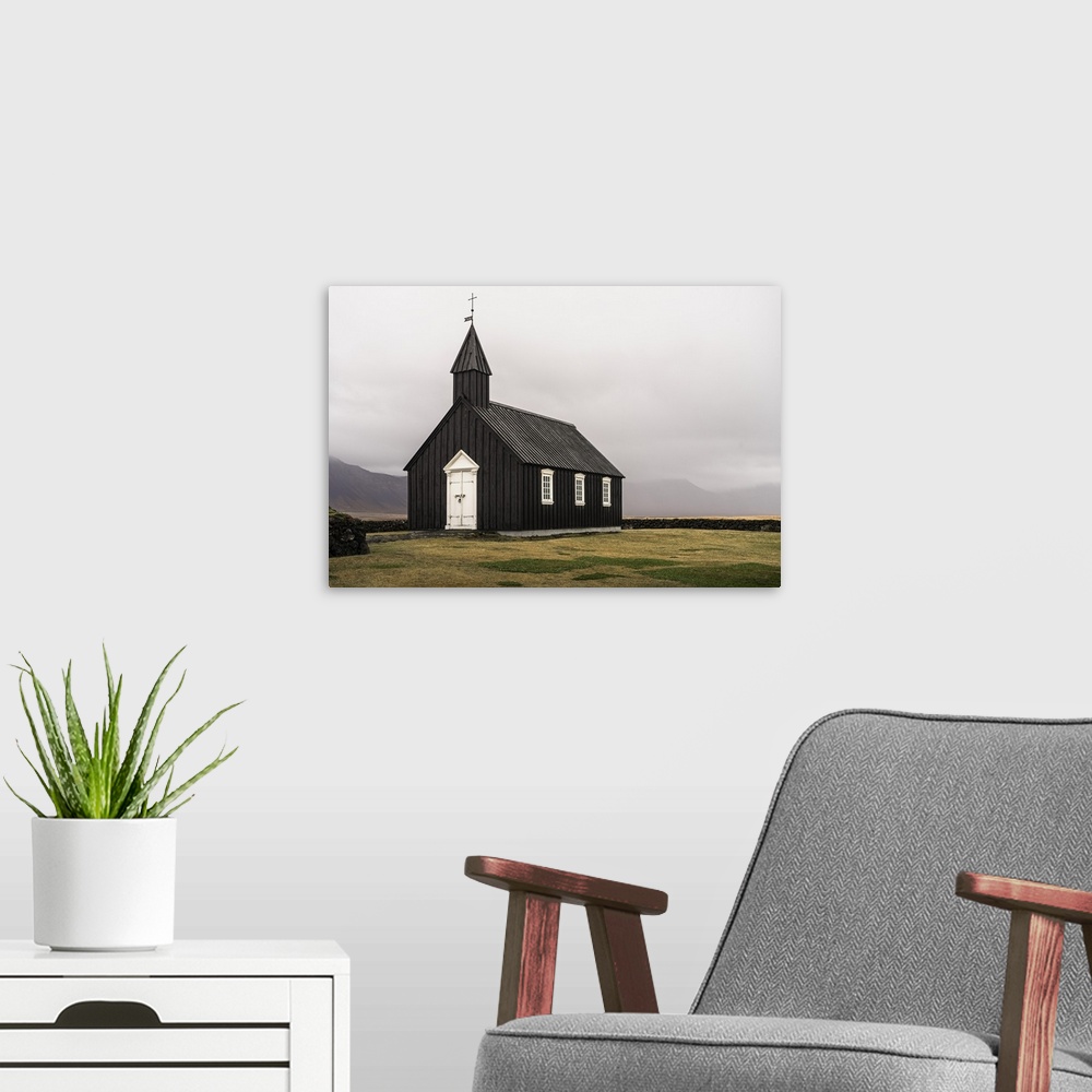 A modern room featuring Snaefellsnes peninsula, Iceland, Europe. The small black church in Budir.