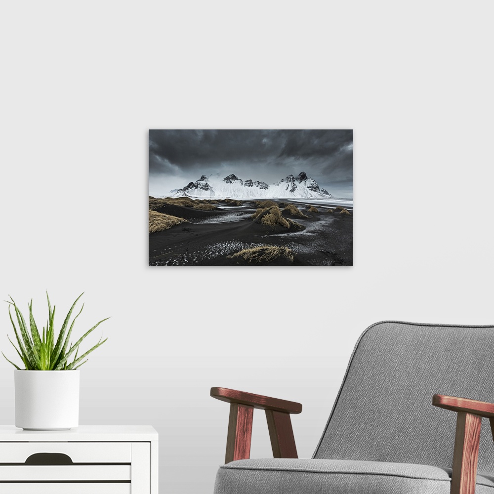 A modern room featuring Stormy weather above Vestrahorn, depicted from Stokksens.