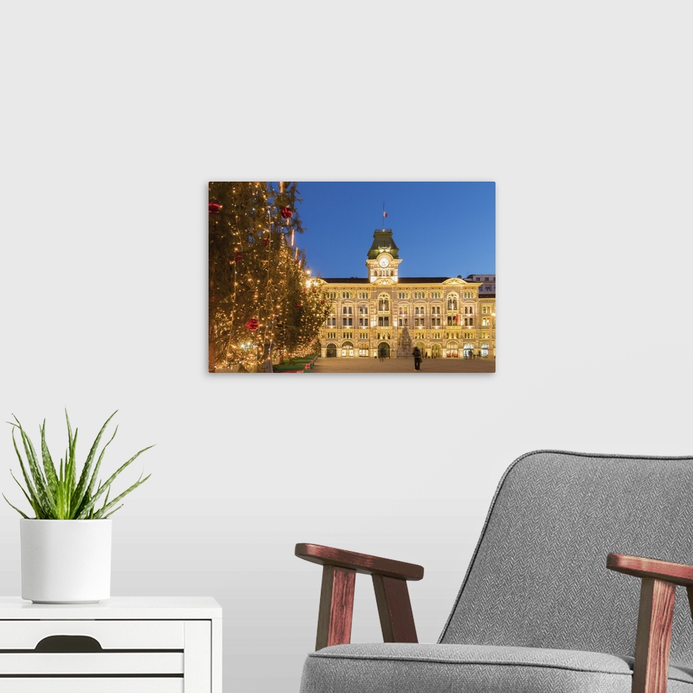 A modern room featuring The city hall in Unita d'Italia square in Trieste in Christmas time at dusk. Trieste city, Triest...