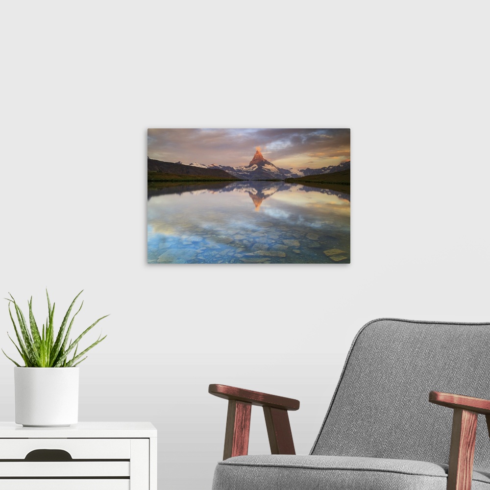 A modern room featuring The Matterhorn, Zermatt, Switzerland. The first reflections at sunrise in the waters of Stellisee...