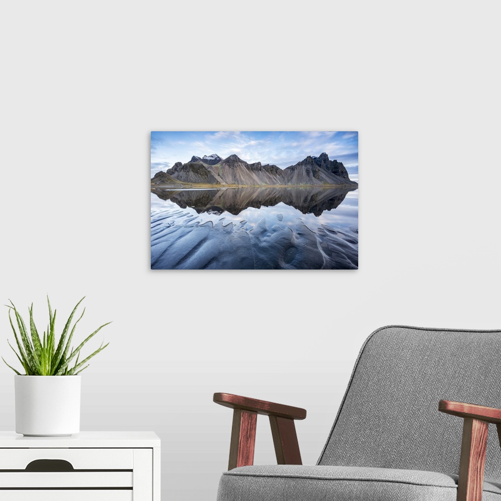 A modern room featuring The mountains reflect on the surface of the ocean. Stokksnes, Eastern Iceland, Europe.