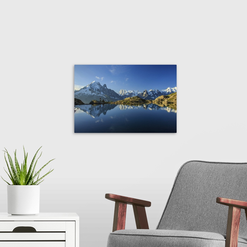 A modern room featuring Photographers and hikers on the shore of Lac De Cheserys at dawn, Haute Savoie, France, Europe.