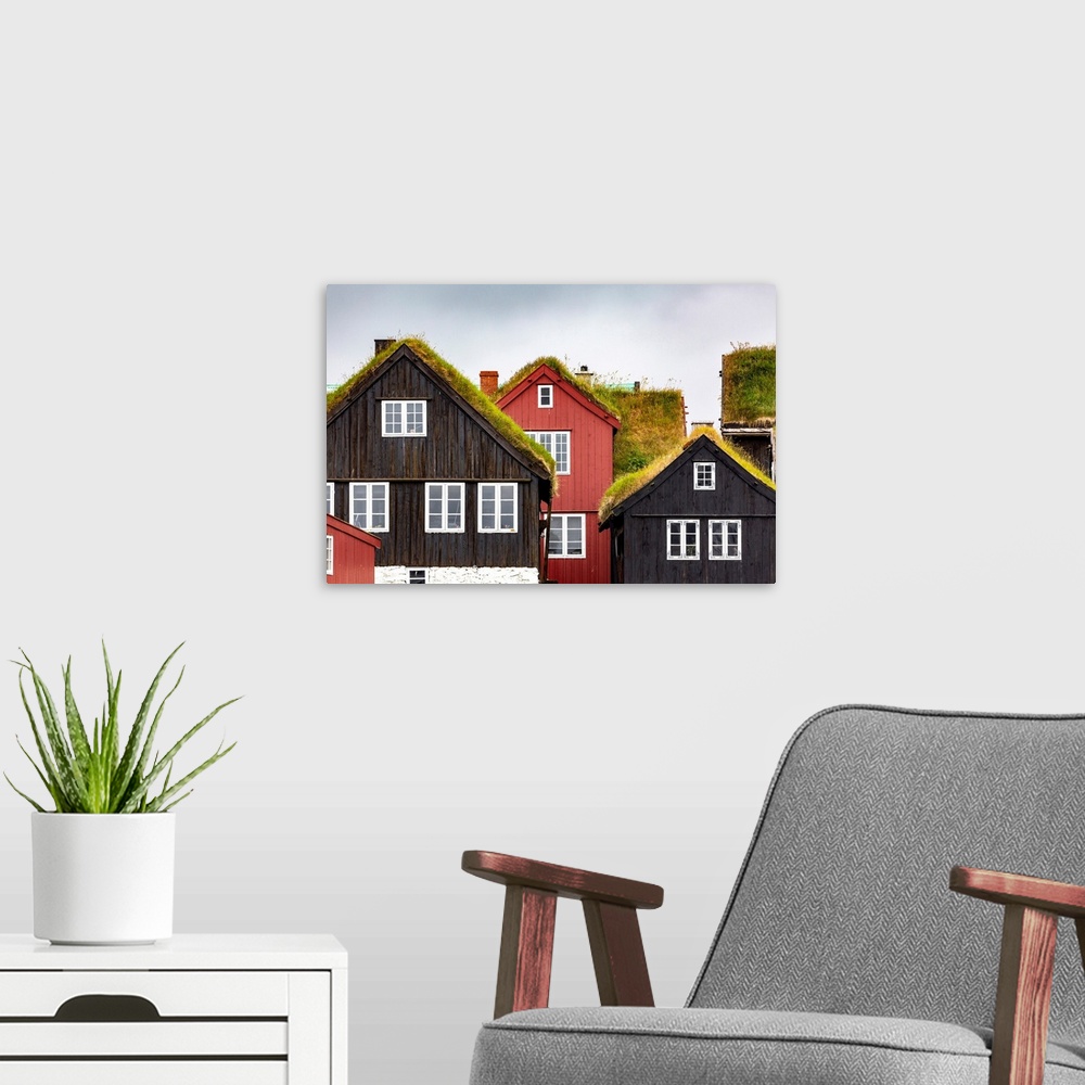 A modern room featuring Torshavn, Faroe Islands, Europe. Typical houses with grass over the roof.