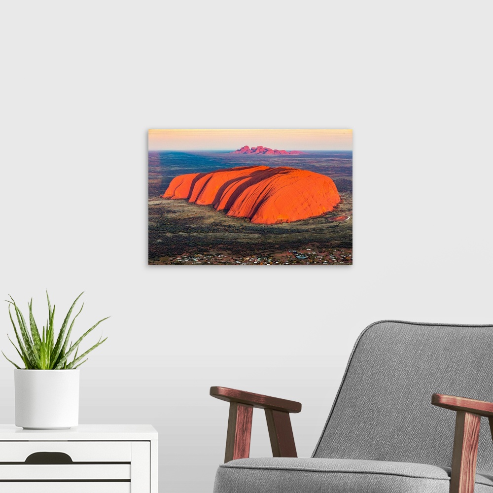 A modern room featuring Uluru and Kata Tjuta at sunrise, Aerial view. Northern Territory, Australia.