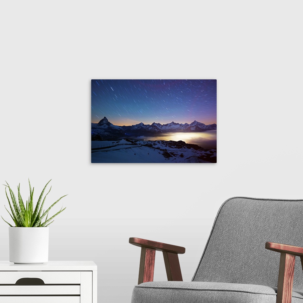 A modern room featuring Europe, Valais, Swiss Alps, Switzerland, Zermatt, The Matterhorn (4478m) and town lights.