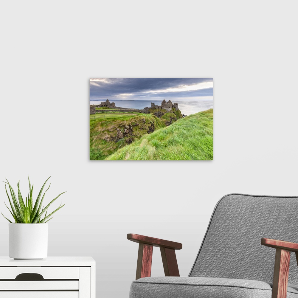 A modern room featuring View of the ruins of the Dunluce Castle. Bushmills, County Antrim, Ulster region, Northern Irelan...