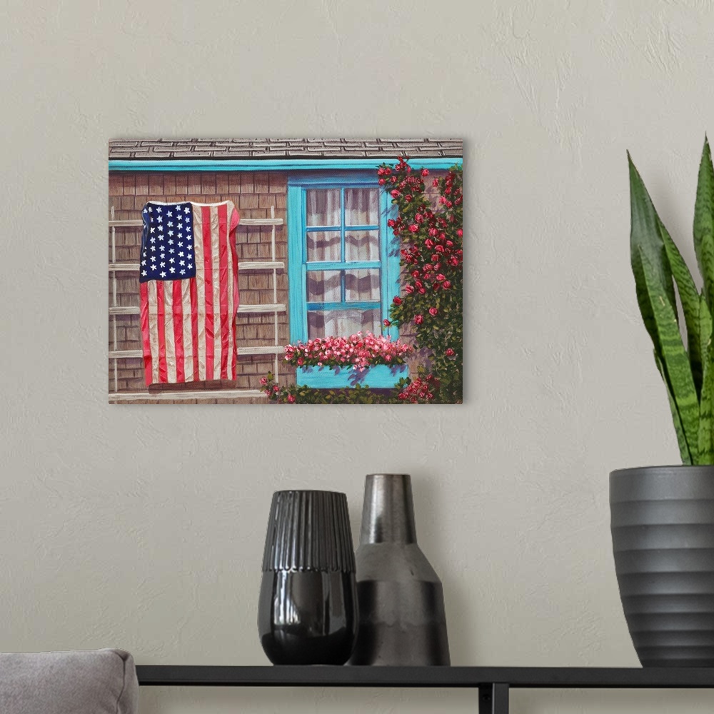 A modern room featuring American flag on siding of house next to a window with window flower box.